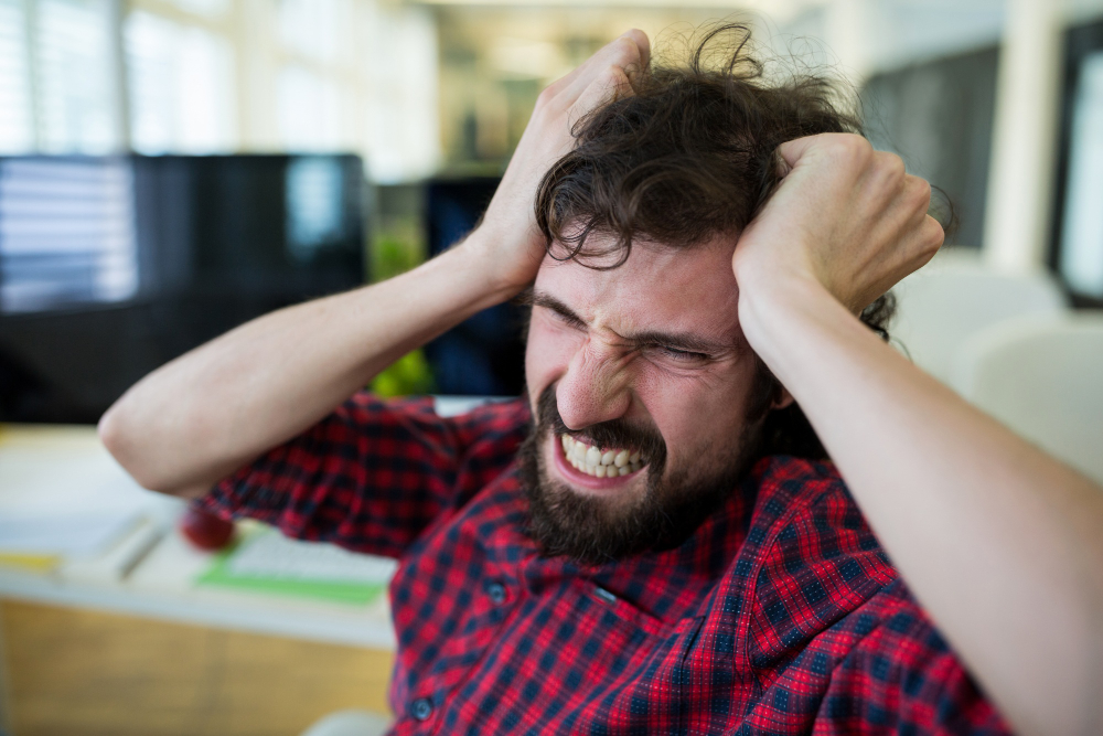 Frustrated male graphic designer in office