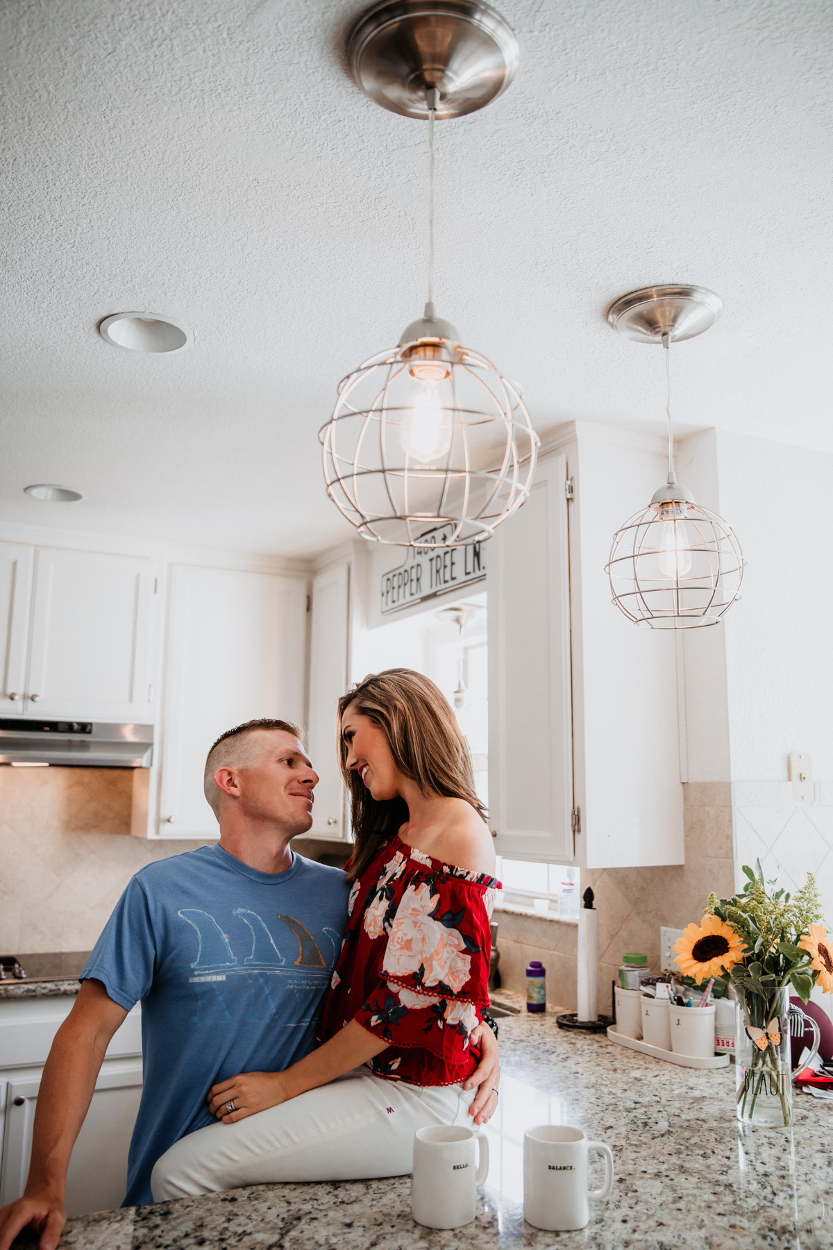 Clear glass pendant light above kitchen sink, installed with Worth Home Products recessed lighting conversion kit for an easy home lighting upgrade.