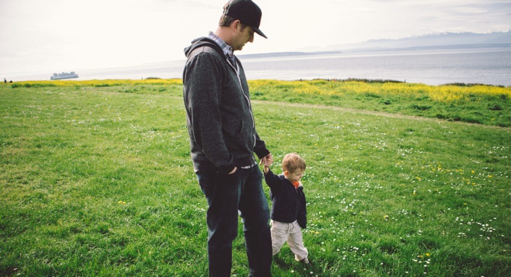 father and son walking hand-in-hand