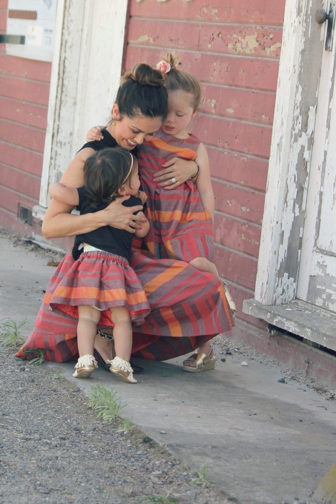 mom and two daughters hugging