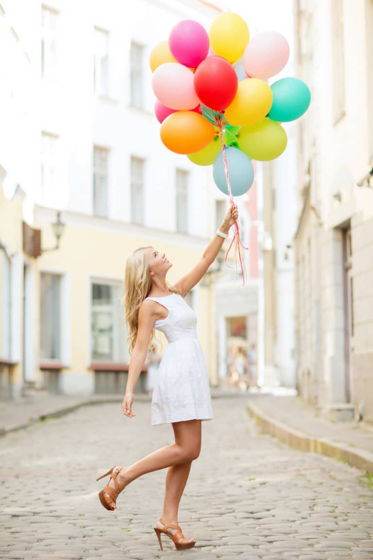 summer holidays, celebration and lifestyle concept - beautiful woman with colorful balloons in the city