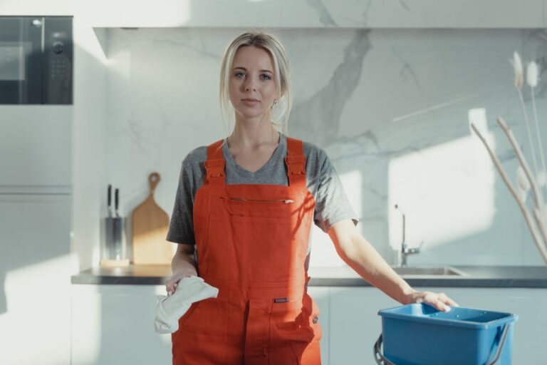 Woman in Red Apron Holding Blue Plastic Container