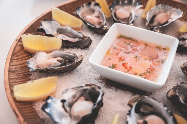 Delicious oysters with lemons and sauce served on ice