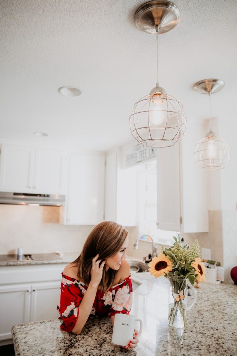 Modern farmhouse kitchen with brushed nickel pendant lights installed using Worth Home Products recessed lighting conversion kits.