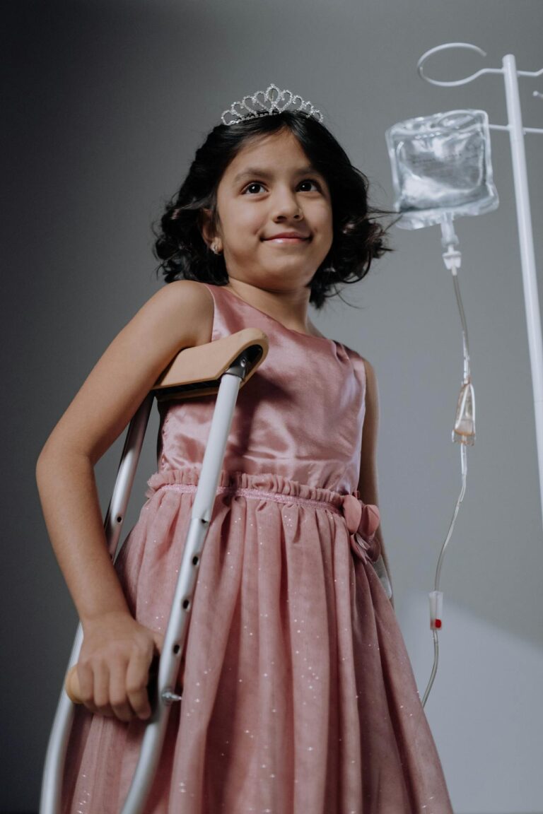 Photo by cottonbro studio: https://www.pexels.com/photo/a-pretty-girl-in-a-pink-dress-standing-with-a-crutch-6191532/