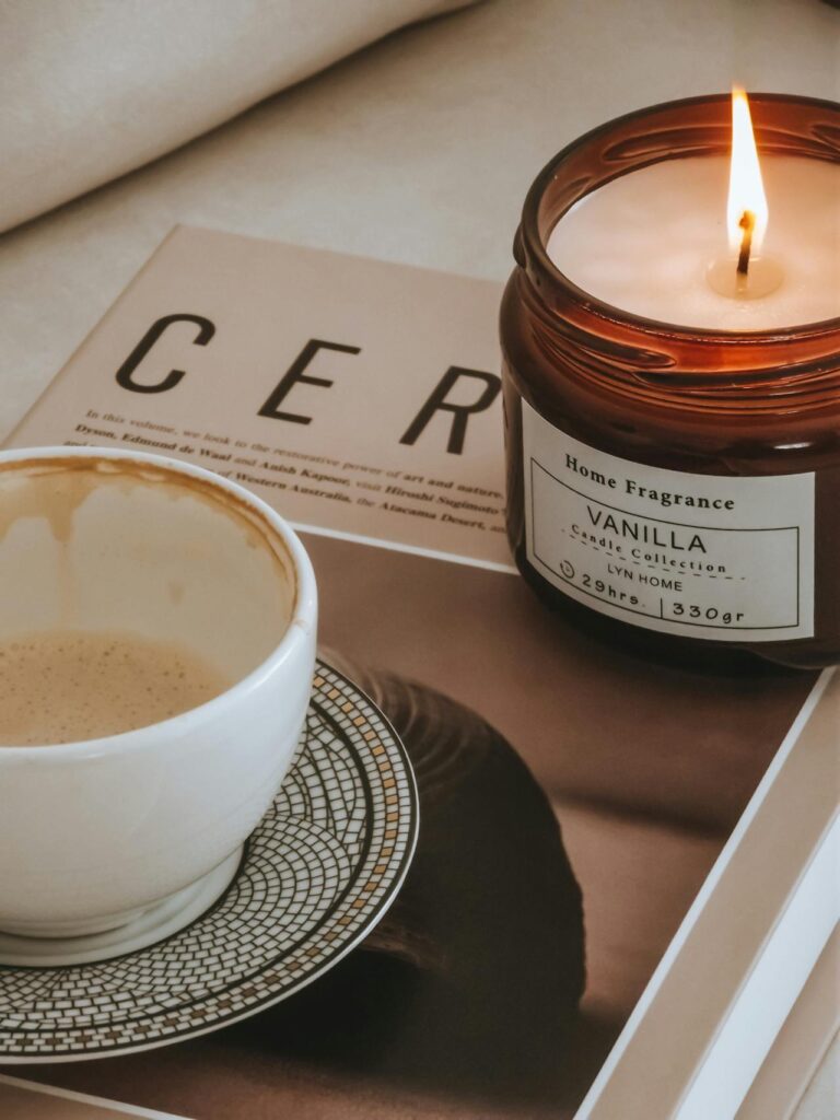 Cup of Coffee Beside a Candle