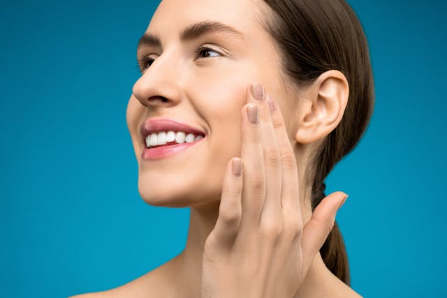 Woman Touching Her Cheeks