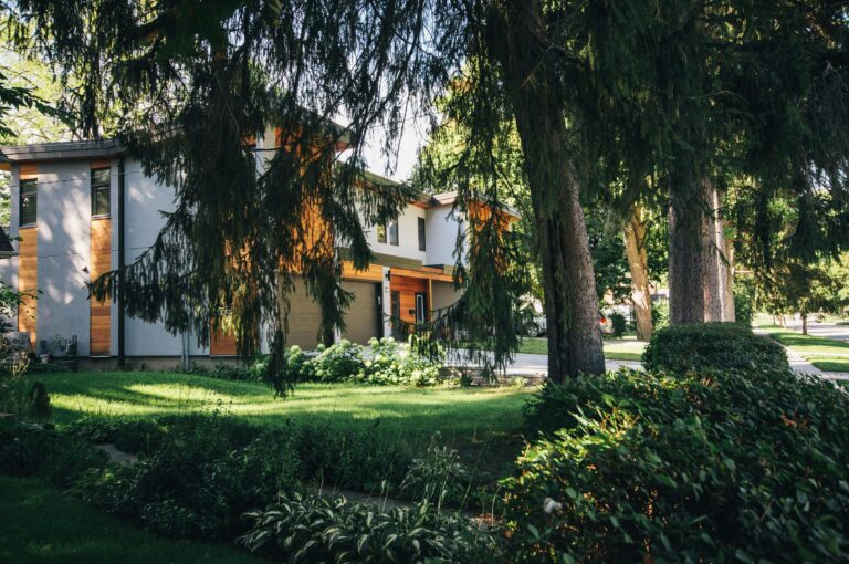 House exterior with trees and grass.